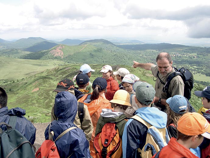 Classe et professeur en randonnée avec vue sur les volcans