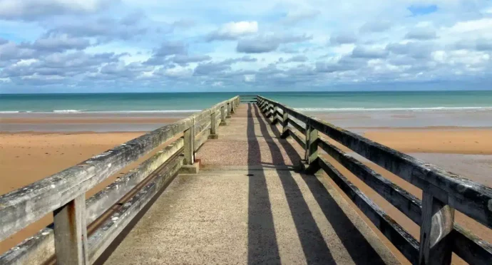 chemin avec barrière sur une plage de normandie avec mer